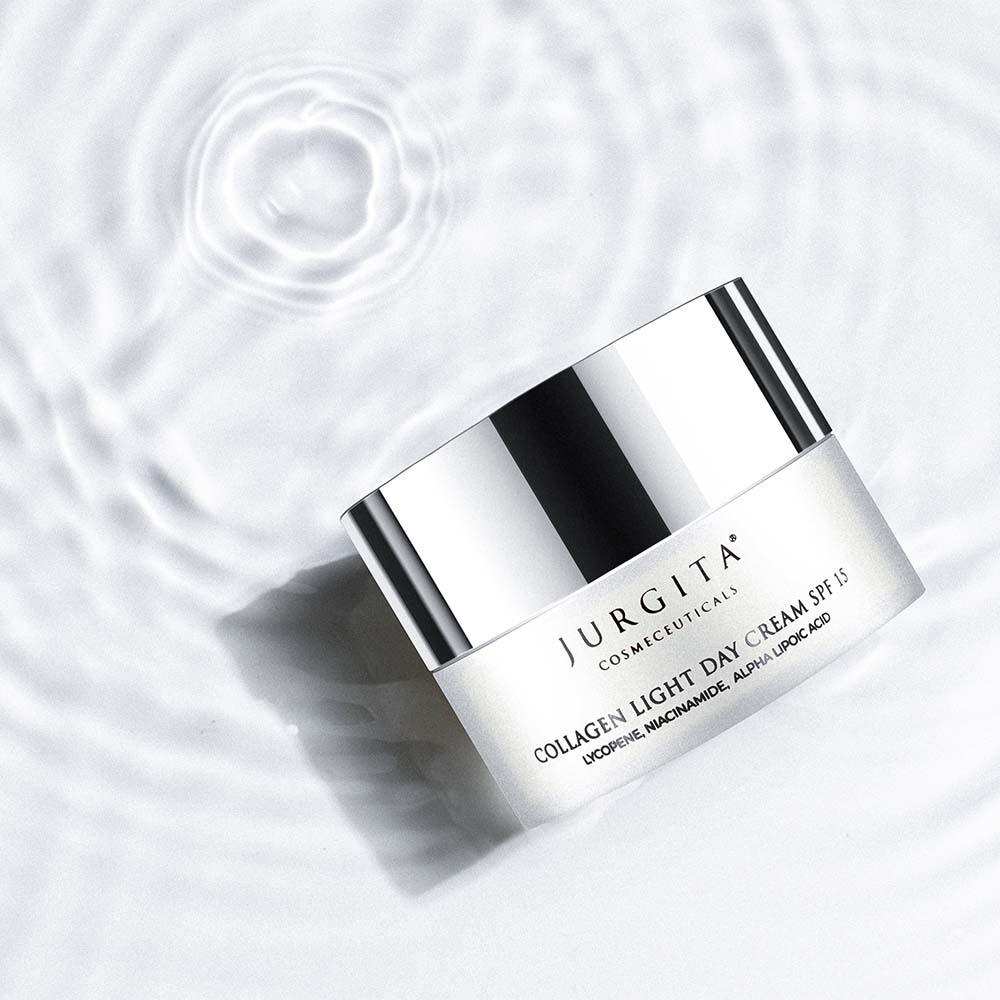 Jurgita Cosmeceuticals Collagen Light Day Cream SPF 15 floating on a rippling water surface, emphasizing its deeply hydrating and protective skincare benefits.