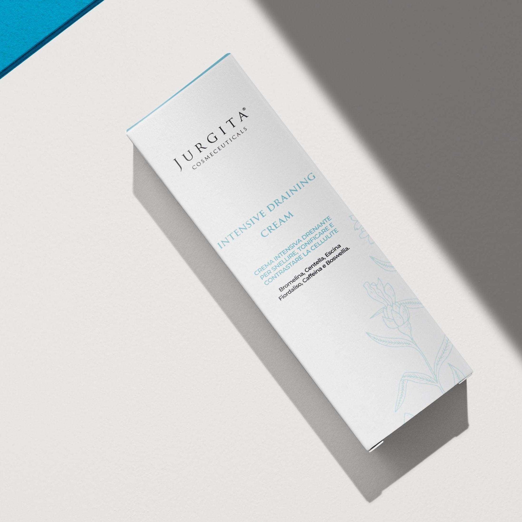 Jurgita Cosmeceuticals Intensive Draining Cream packaging displayed on a textured surface, highlighting its detoxifying and anti-inflammatory skincare benefits.