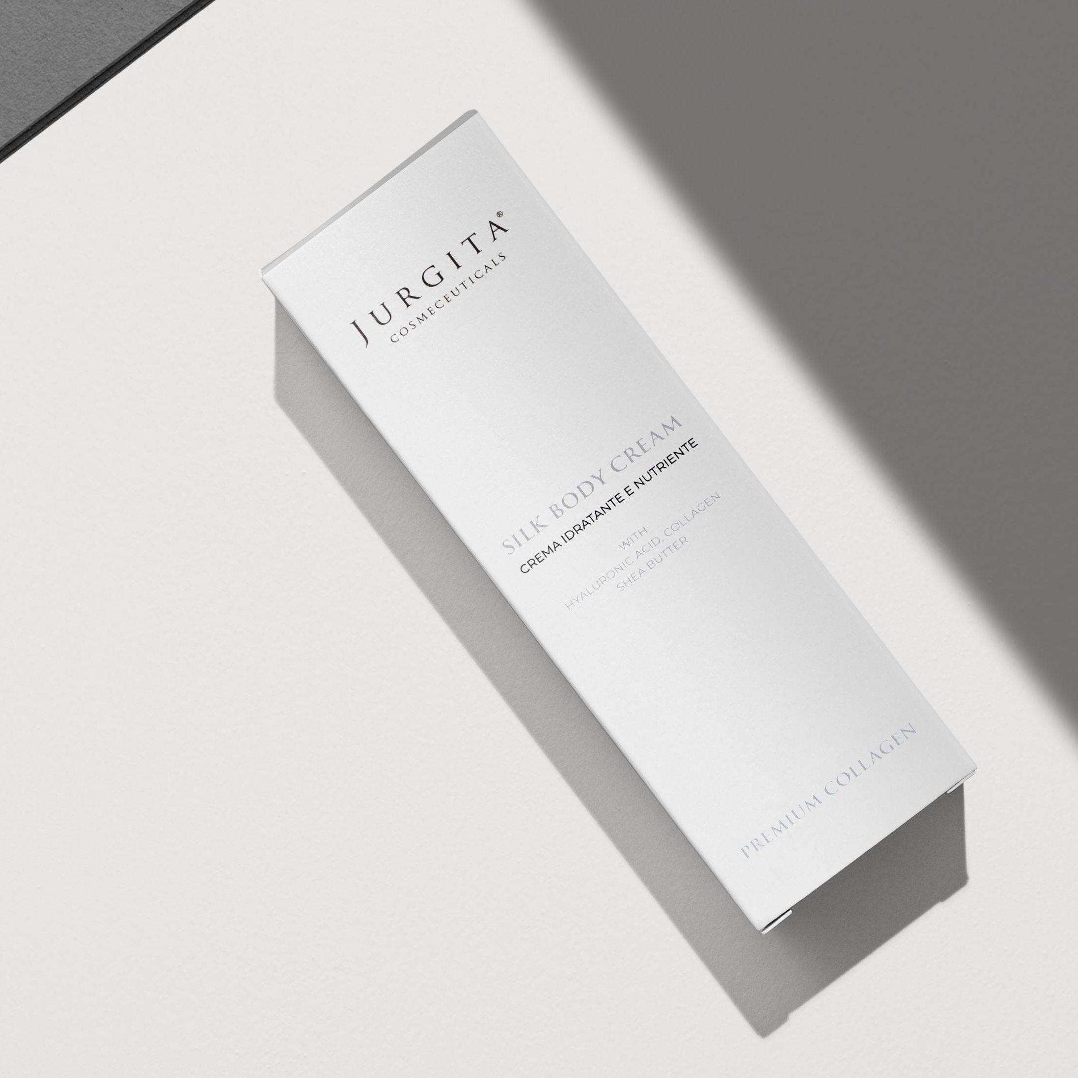 Jurgita Cosmeceuticals Silk Body Cream in an elegant white pump bottle, formulated with hyaluronic acid, collagen, and shea butter for deep hydration and anti-aging benefits.