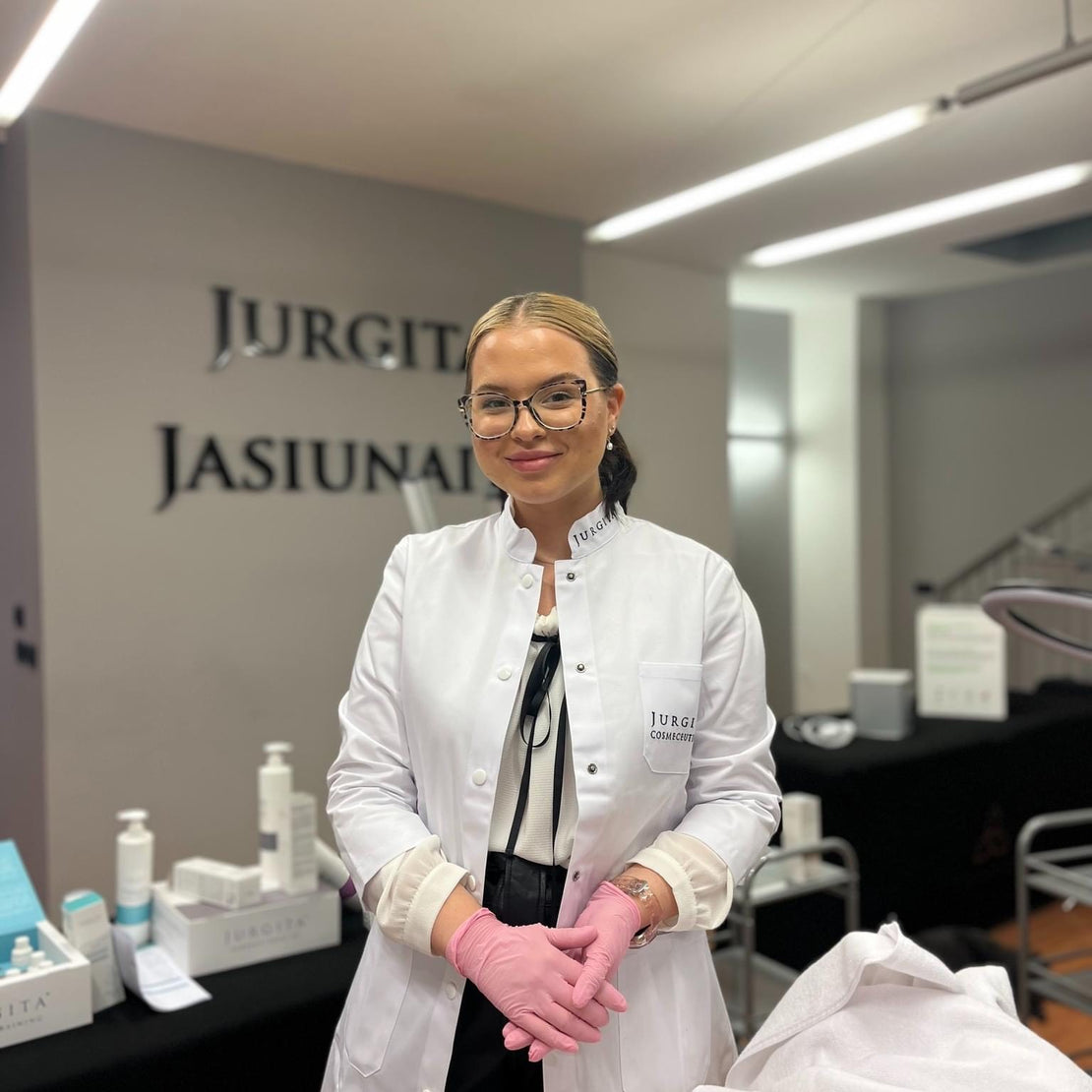 Ugnė Šeržentaitė, CIDESCO-certified cosmetologist and Jurgita Cosmeceuticals trainer, standing in a professional skincare training studio.