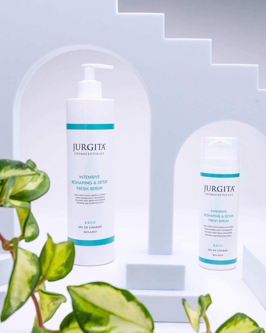 Jurgita Cosmeceuticals Intensive Reshaping & Detox Fresh Serum in two sizes, elegantly displayed with green leaves to highlight its natural detoxifying ingredients.