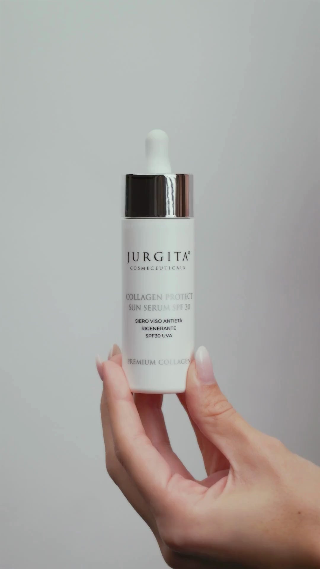 A hand dispensing and spreading the Jurgita Cosmeceuticals Collagen Protect Sun Serum SPF 30, revealing its smooth, non-greasy texture and effortless absorption into the skin