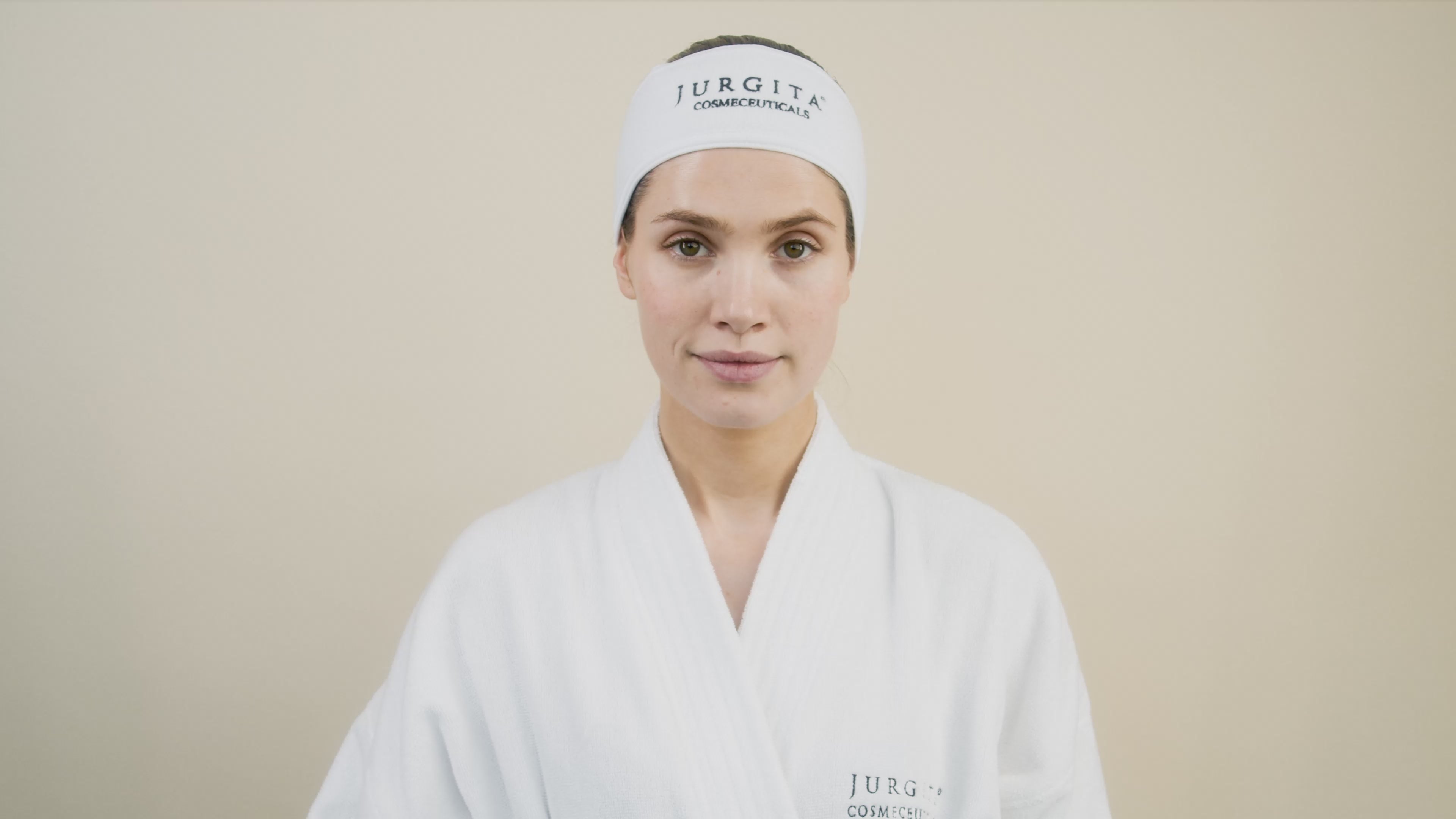 A model applies Jurgita Cosmeceuticals Intensive Draining Cream to her legs, demonstrating its lightweight texture and deep hydration benefits.