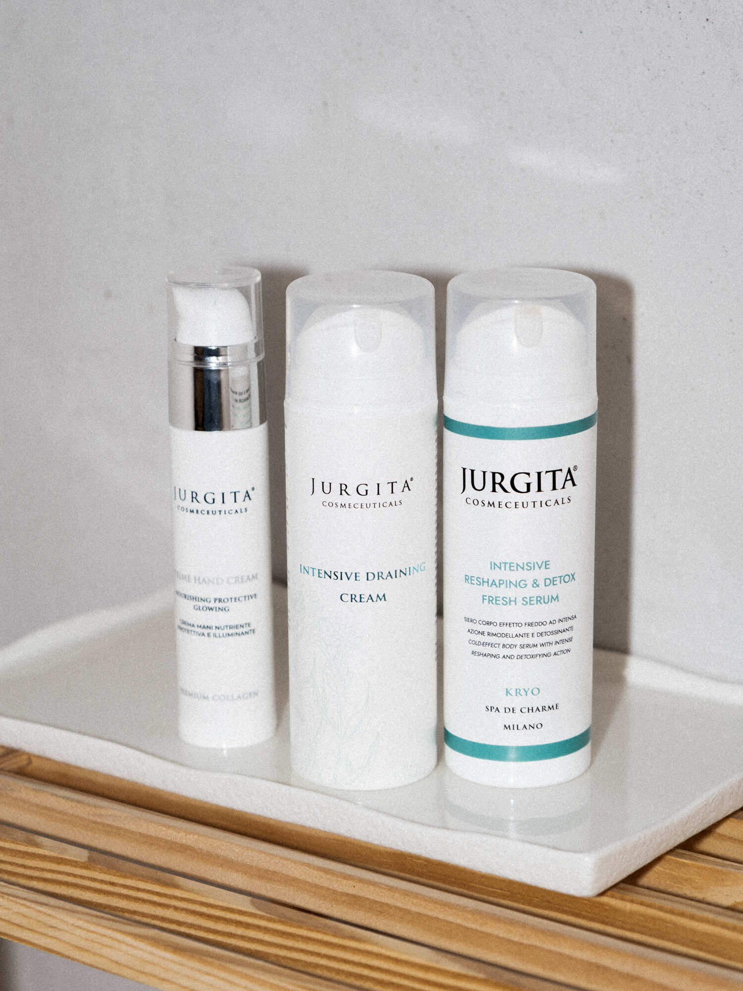 Jurgita Cosmeceuticals Body Elegance Trio Set – hand cream, draining cream, and detox serum displayed on a minimal, elegant background.