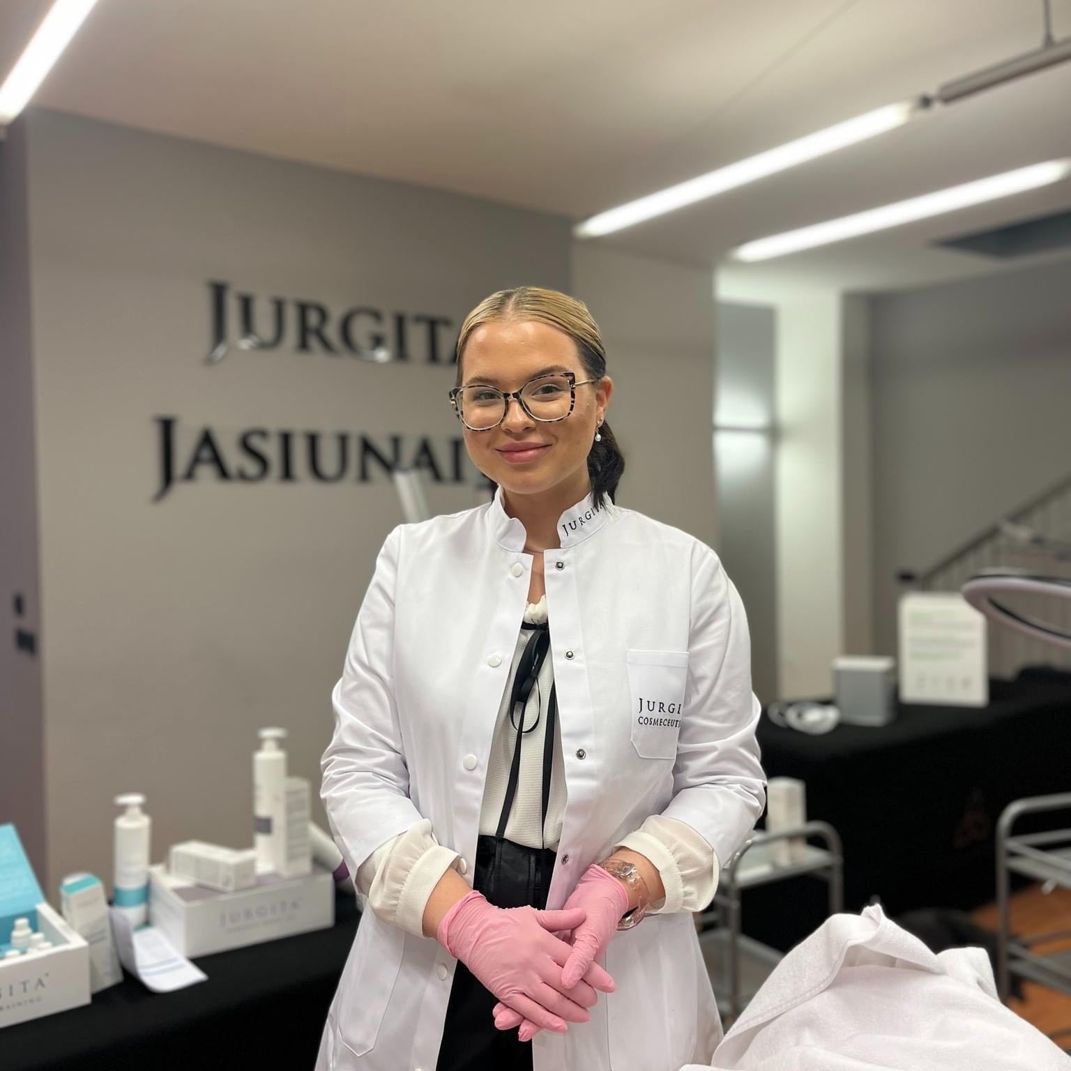 Ugnė Šeržentaitė, CIDESCO-certified cosmetologist and Jurgita Cosmeceuticals trainer, standing in a professional skincare training studio.